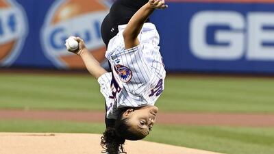 Olympic gold medallist Laurie Hernandez performs flips from the mound before throwing out the ceremonial first pitch before the baseball game between the New York Mets and the Washington Nationals in New York. Kathy Kmonicek / AP Photo