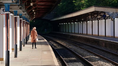 A passenger waits at Great Malvern station in Worcestershire, central England. AP