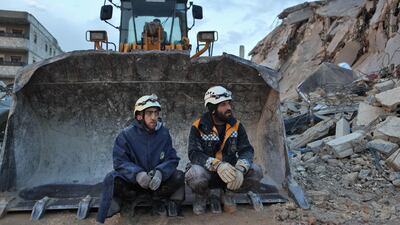 White Helmet Syrian rescue workers sit on an excavator in the town of Sarmada, Syria. AFP