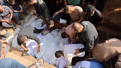 The bodies of Palestinians killed in Israeli strikes are buried in Jabalia, in northern Gaza. AFP