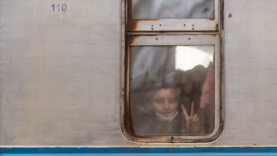 A Ukrainian refugee makes a V-sign after arriving in Przemysl, south-eastern Poland, by train from Lviv, western Ukraine. Taken by Maja Smiejkowska. PA
