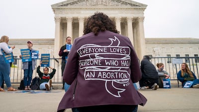 A pro-choice activist wears a jacket that reads: Everyone loves someone who has had an abortion. EPA