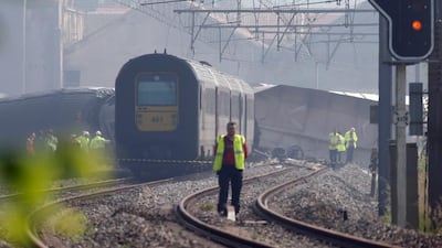 Officials stand near the wreckage of a passenger train on June 6, 2016 after it crashed into the back of a freight train in Saint-Georges-Sur-Meuse,eastern Belgium. Francois Lenoir / Reuters