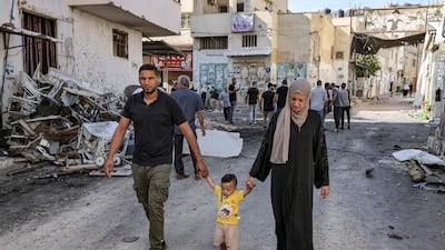 A family in Jenin after the Israeli army bulldozed buildings and stormed a refugee camp that it claims harboured militants. AFP