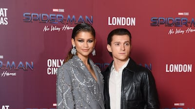 Zendaya and Tom Holland, in a white shirt and black leather jacket, attend a 'Spiderman: No Way Home' photocall in London on December 5, 2021. Getty Images)