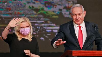 Israeli Prime Minister Benjamin Netanyahu, leader of the Likud party, appears with his wife Sara to address supporters at the party campaign headquarters in Jerusalem. AFP