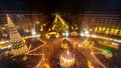 People visit a Christmas fair in Bucharest, Romania. AP