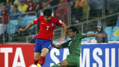 South Korea's Son Heung-min, left, is tackled by Iraq's Alaa Abdulzehra during the Asian Cup quarter-finals on Monday. Edgar Su / Reuters / January 26, 2015