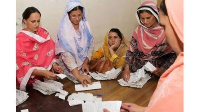Election commission officials count votes in Muzaffarbad, the capital of Pakistani-administered Kashmir. Rahat Dar / EPA