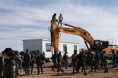 Police were sent in with heavy machinery to evict settlers from the illegal outpost. AFP