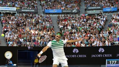 Switzerland’s Roger Federer plays a backhand return during his men’s singles match against Georgia’s Nikoloz Basilashvili on Day 1 of the 2016 Australian Open in Melbourne on January 18, 2016. Saeed Khan / AFP