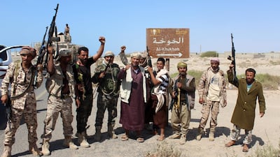 A file photo taken on December 10, 2017 shows Yemeni fighters loyal to the Saudi-backed Yemeni president gesturing and shout slogans as they stand on a road leading to the town of Khokha which was retaken from Houthi rebels, about 120 kilometres south of the Houthi rebel-held Red Sea port of Hodeidah. Saleh Al-Obeidi / AFP