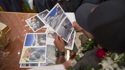 A member of the team that scaled Everest gives photographs to young guests and students during a Sea Palace barza. Mohamed Al Hammadi / Crown Prince Court - Abu Dhabi