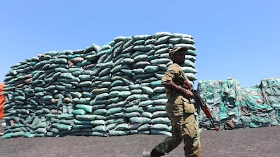 A Somalian soldier walks past a consignment of charcoal destined for the export market in Barawe October 12, 2014. Reuters