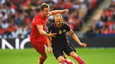 Barcelona midfielder Andres Iniesta evades Jordan Henderson. Michael Regan / Getty Images