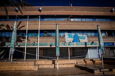 Closed sun parasols outside a shuttered beachside bar and restaurant in Lloret de Mar, Spain. Bloomberg