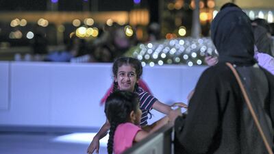 Young kids training themselves on the wax ice ring at the Winter Wonderland event on the Maryah Island waterfront promenade.