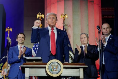 OSTP director Michael Kratsios, left, applauds after US President Donald Trump signed executive orders related to artificial intelligence. Reuters