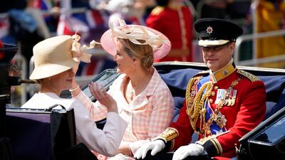 Prince Edward and his wife Sophie, Countess of Wessex ride in a carriage as the Royal Procession leaves Buckingham Palace for the Trooping the Color ceremony. AP