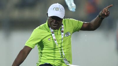 Burkina Faso manager Kamou Malo kicks a plastic bottle. AFP