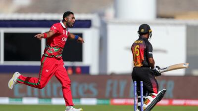 Oman's K Kaleemullah, left, celebrates after dismissing Papua New Guinea's Lega Siaka. AP