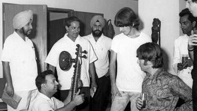 George Harrison and John Lennon of The Beatles are given a sitar demonstration at a music shop in New Delhi in 1966. Mark and Colleen Hayward / Redferns