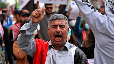 A protester chants anti-government slogans during a rally in Baghdad, Iraqs. AP Photo
