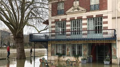Pedestrians walk along the Seine river in the Chatou suburb of Paris, France. Pascal Le Segretain / Getty Images
