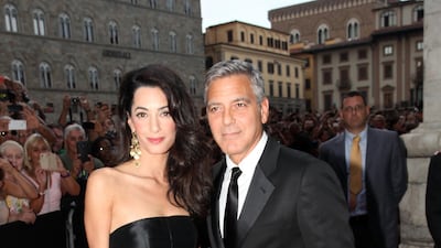 Amal Clooney, in a classic Dolce & Gabbana gown, and George Clooney attend the Celebrity Fight Night Gala on September 7, 2014 in Florence, Italy. Getty Images
