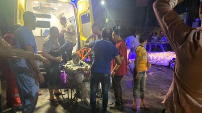 People tend to an injured man after a blast outside the National Cancer Institute, Cairo, Egypt. EPA