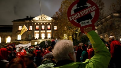 A protester holds a placard reading "stop coal" during a rally in Berlin / AFP PHOTO / Odd ANDERSEN