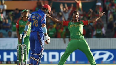 Rubel Hossain, right, celebrates taking the wicket of Afsar Zazai Bangladesh's World Cup win over Afghanistan. Peter Parks / AFP