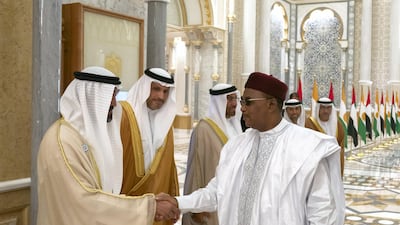 Mohamed Al Mazrouei, Undersecretary of the Crown Prince Court of Abu Dhabi (left) greets Mahamadou Issoufou, President of Niger, during a reception at the Presidential Palace in December 2018. Hamad Al Kaabi / Ministry of Presidential Affairs