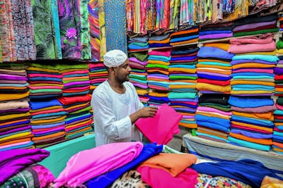 A fabric seller at his shop in Port Sudan before Eid Al Fitr. But there is no end in sight in the civil war. AFP