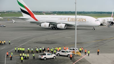 Ground crews watch an Emirates flight from Dubai taxi-ing towards a gate in 2008 as it becomes the first commercial Airbus A380 jet to land in the US, at JFK International Airport in New York. AFP