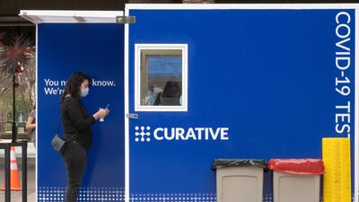 A woman holds a nasal swab after collecting her own test sample at a Curative Inc. Covid-19 testing site in downtown Riverside, California, U.S. Greater Los Angeles is emerging as America's hardest hit metropolitan area as Covid-19 sweeps across California like never before. Bloomberg
