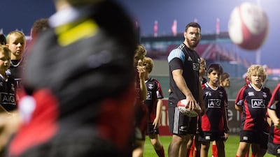 Ryan Crotty offers some tips to Exile juniors during the training session. Duncan Chard for The National