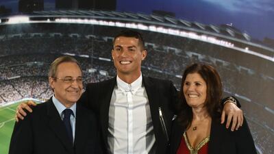 Cristiano Ronaldo poses with Real Madrid club president Florentino Perez and his mother, Maria Dolores dos Santos Aveiro, during the official presentation of Ronaldo’s contract renewal in Madrid on November 7, 2016. Gerard Julien / AFP