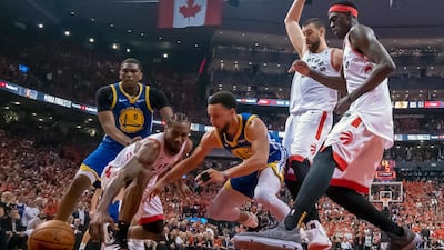 Toronto Raptors forward Kawhi Leonard (2) and Golden State Warriors guard Stephen Curry (30) battle for a loose ball. AP Photo