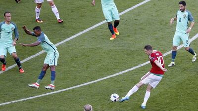 Zoltan Gera (2-R) of Hungary scores the 1-0 goal during the Uefa Euro 2016 Group F preliminary round match between Hungary and Portugal at Stade de Lyon in Lyon, France, 22 June 2016. Sergey Dolzhenko / EPA