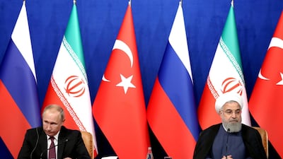 Iran's President Hassan Rouhani, right, with Russia's President Vladimir Putin, left, at a summit on Friday to discuss the war in Syria. Ebrahim Noroozi / Ap