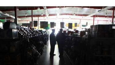 Supermarket customers shop in the dark during a blackout in Sharjah.