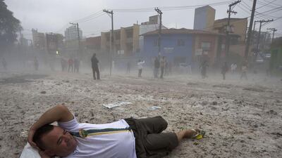 A man lies for fun on a layer of hail in a street after a hailstorm in the Aclimacao neighbourhood in Sao Paulo, Brazil. After the severe overnight hailstorm a layer of hailstones as deep as 20 centimetres covered streets and parks, drawing people to make snowmen and play in the ice, an unusual scene to the city. Nelson Almedia / AFP