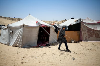 Ola Nassar, 41, who was displaced by the Israeli bombardment of the Gaza Strip, at a makeshift tent camp in Khan Younis. AP