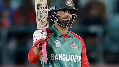 Bangladesh's Tamim Iqbal acknowledges his fifty runs during the ICC World Twenty20 2016 cricket tournament against Oman at the Himachal Pradesh Cricket Association (HPCA) stadium in Dharamsala, India, Sunday, March 13, 2016. (AP Photo /Tsering Topgyal)