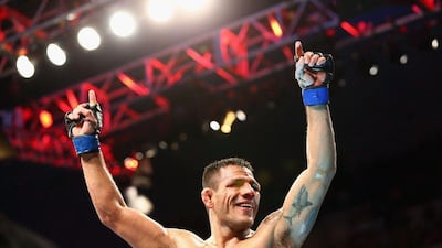 Rafael dos Anjos celebrates his win against Anthony Pettis in the lightweight title bout at UFC 185 on Saturday in Dallas, Texas. Ronald Martinez / Getty Images / AFP / March 14, 2015