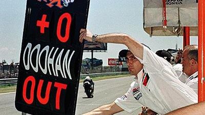 A pit lane board signals Mick Doohan has crashed out of the 1992 Dutch Grand Prix. He was hours away from losing his leg to gangrene.