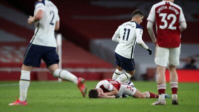 Tottenham Hotspur's midfielder Erik Lamela fouls Arsenal's defender Kieran Tierney. AFP