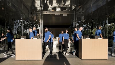 Employees walk out to kiosks ahead of the Apple event. Bloomberg