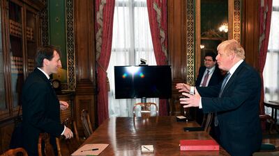 Britain's foreign secretary Boris Johnson, right, stands opposite Richard Ratcliffe, the husband of British-Iranian Nazanin Zaghari-Ratcliffe. Stefan Rousseau / AP